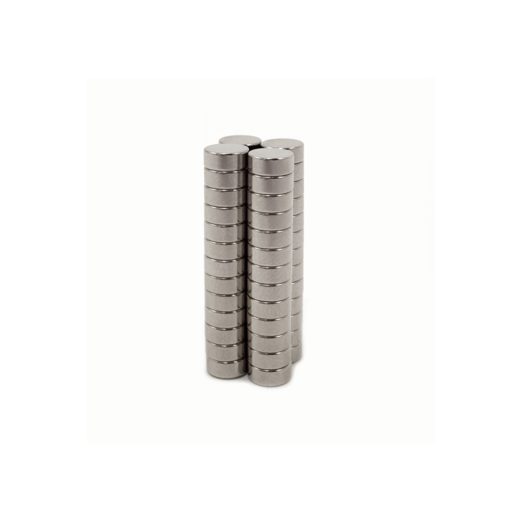Two tall, vertical stacks of identical silver Bare Magnets or metal discs are placed side by side on a white background. by Standex Detect