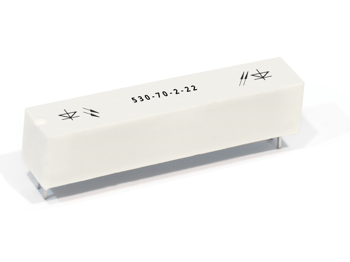 A white rectangular 530-70 Series Optocouplers component with metal pins at the bottom, labeled 530-70-2-22 on top, and marked with diode symbols on both ends. by Standex Detect