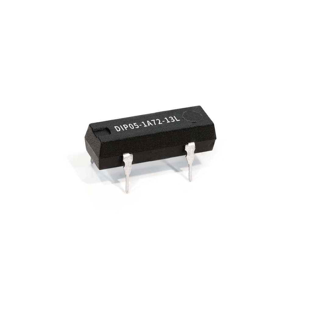 A black, rectangular Reed Relay electronic component with four metal pins, labeled DIP05-1A72-13L, isolated on a white background. by Standex Detect