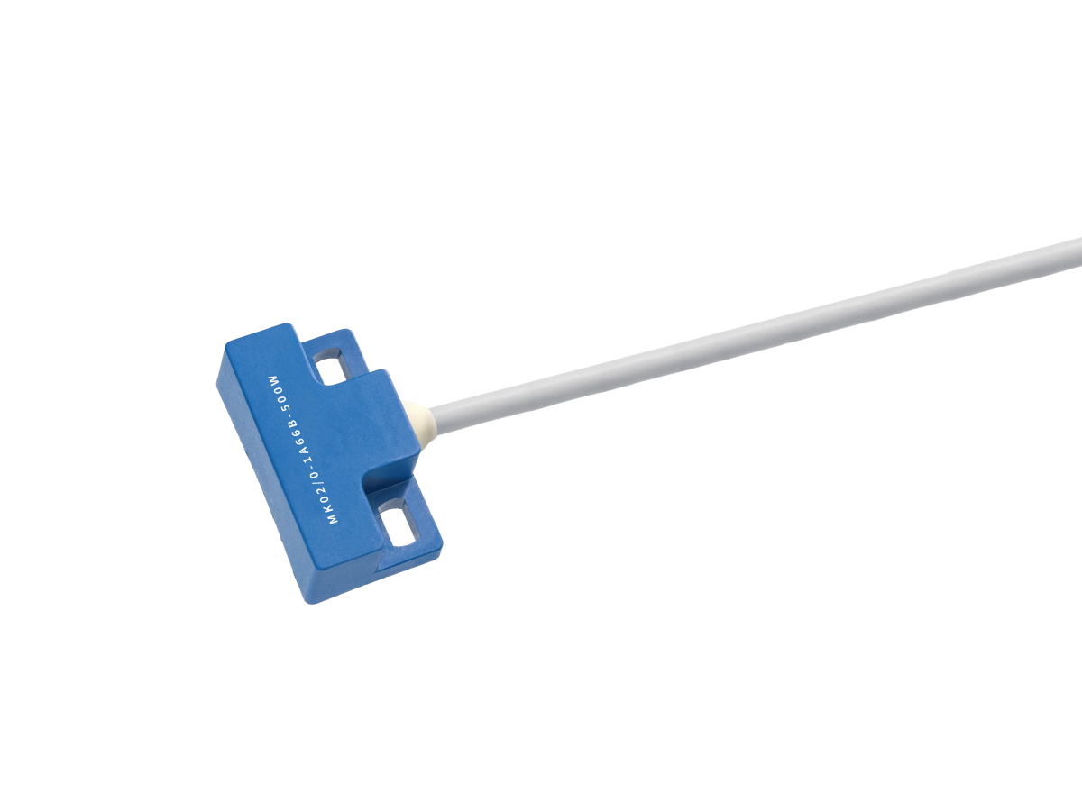 A blue rectangular MK02 Series reed sensor with a white cable attached, photographed against a white background. The device features two holes on each side and small white text printed on its surface. by Standex Detect