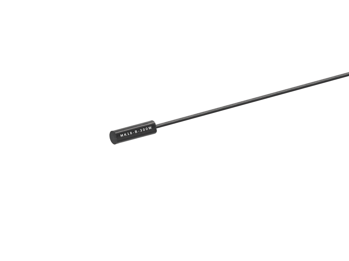 A small, black cylindrical electronic component, part of the MK18 Series Reed Sensor line, with a long thin wire attached and labeled M2K1B-350W, isolated on a white background. by Standex Detect